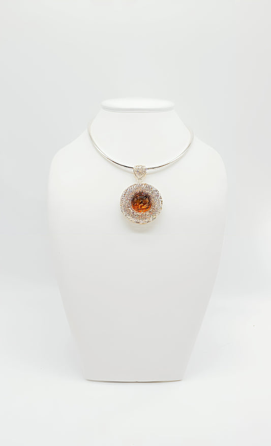 Double-sided shine: amber pendant in a silver frame