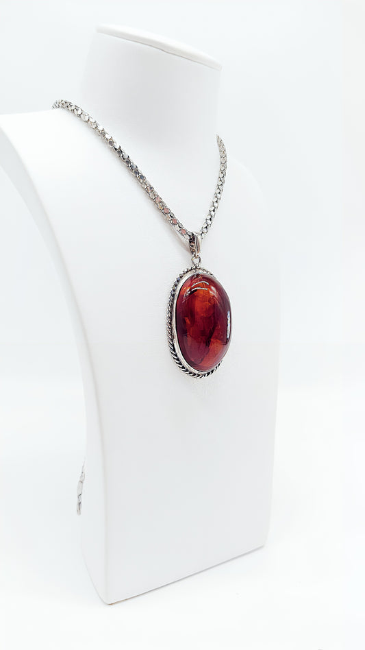 Unique silver pendant with bright amber