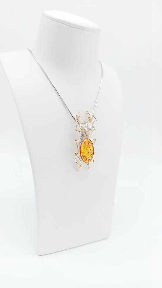 Silver beetle pendant with bright amber
