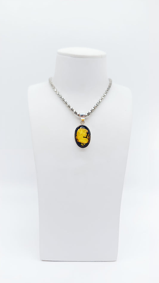 Antique elegance: amber pendant with a woman's profile