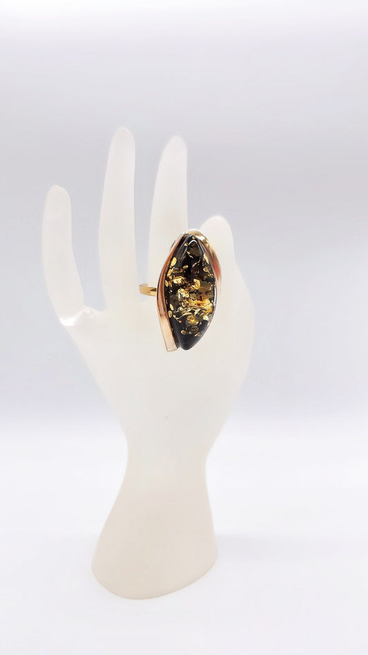Luxurious unique ring made of gold-plated silver and green amber