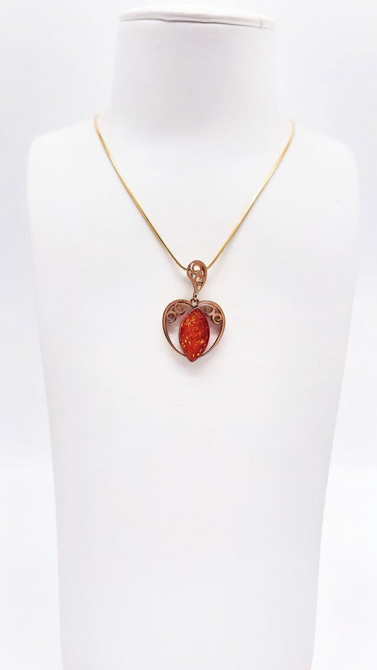 Romantic gold pendant with amber heart