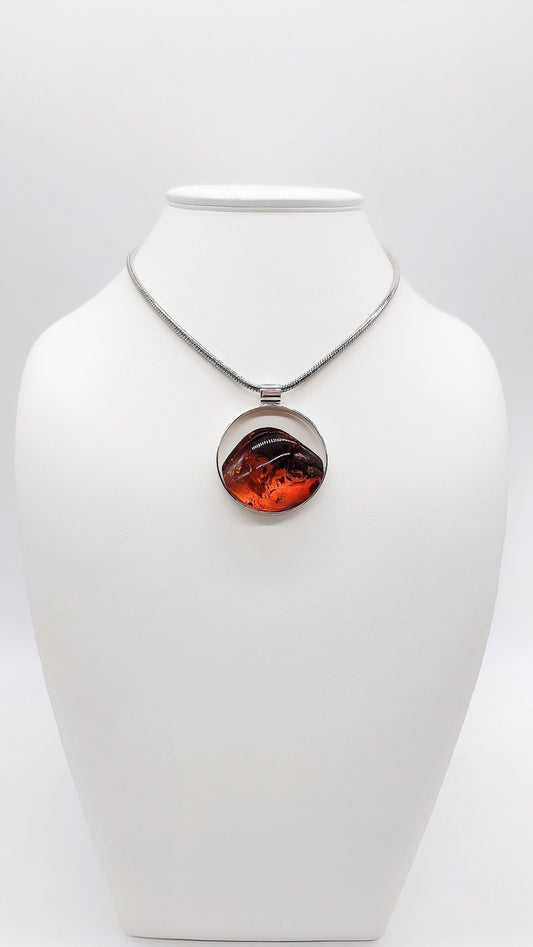 Round amber pendant with silver setting