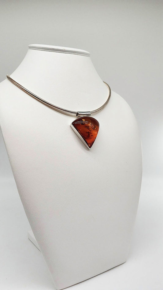 Triangular amber pendant with meaning