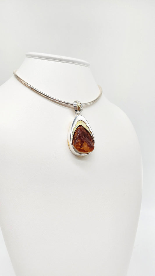Amber drop pendant with gold accents