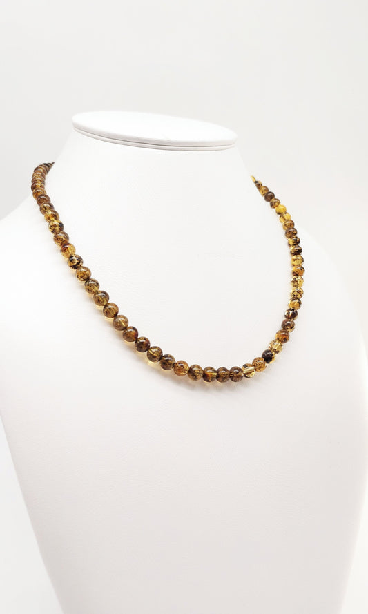 Green shimmering amber necklace as a gift
