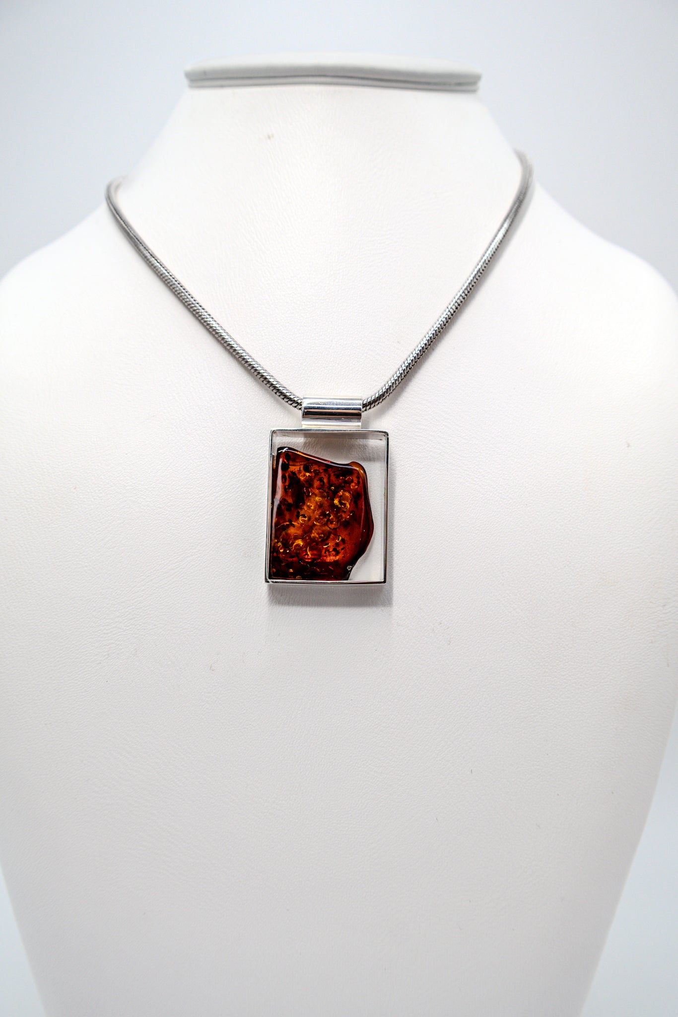 Modern pendant made of silver and amber