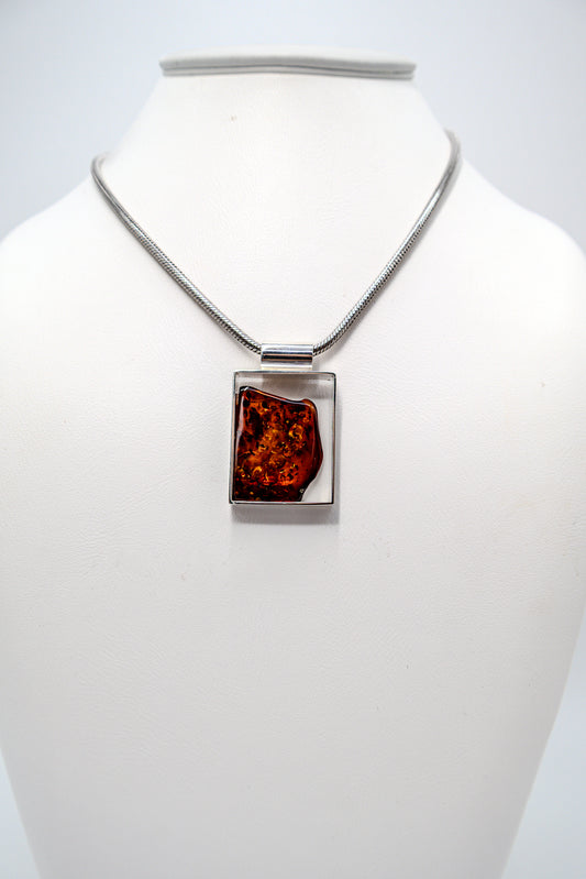 Modern pendant made of silver and amber