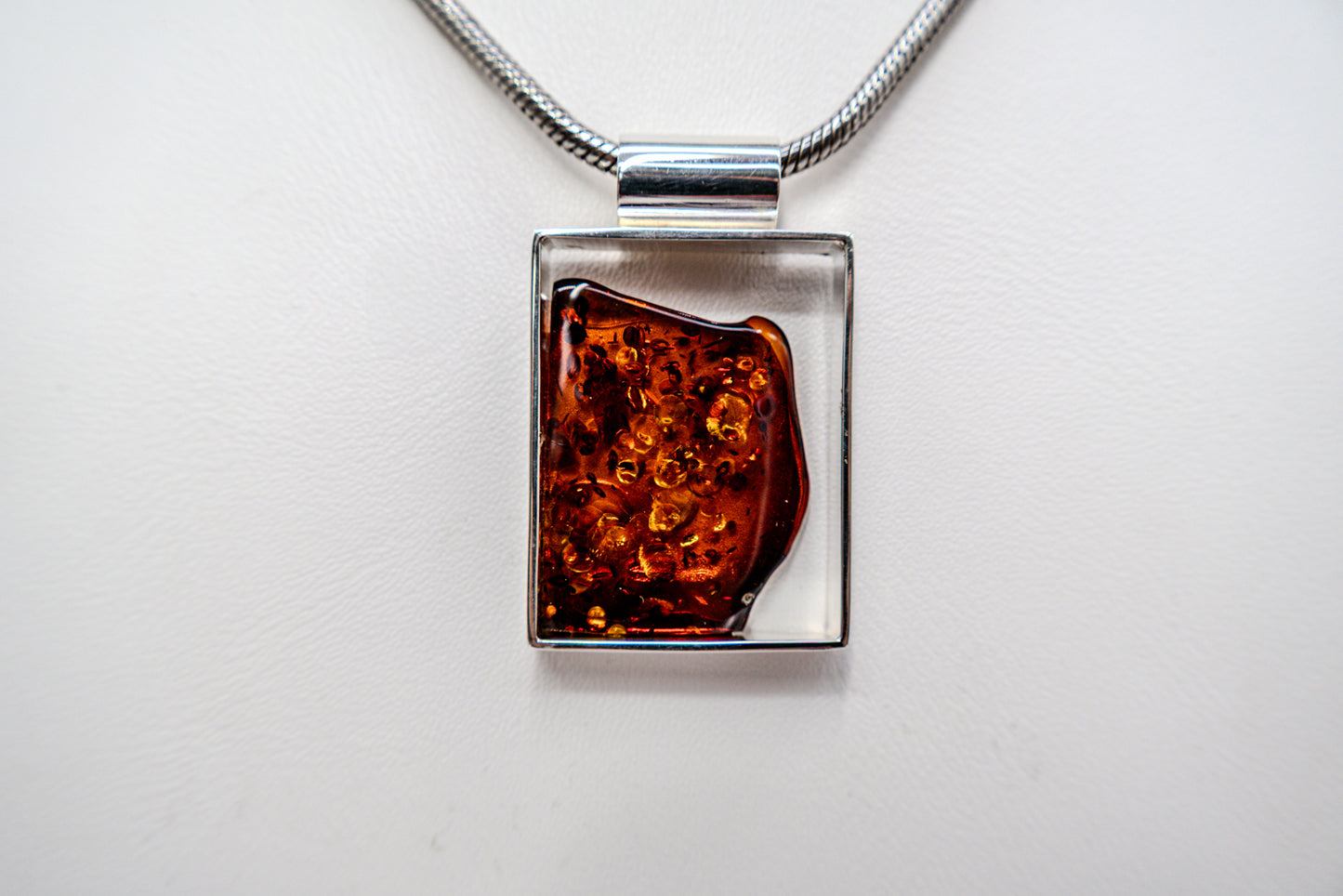 Modern pendant made of silver and amber