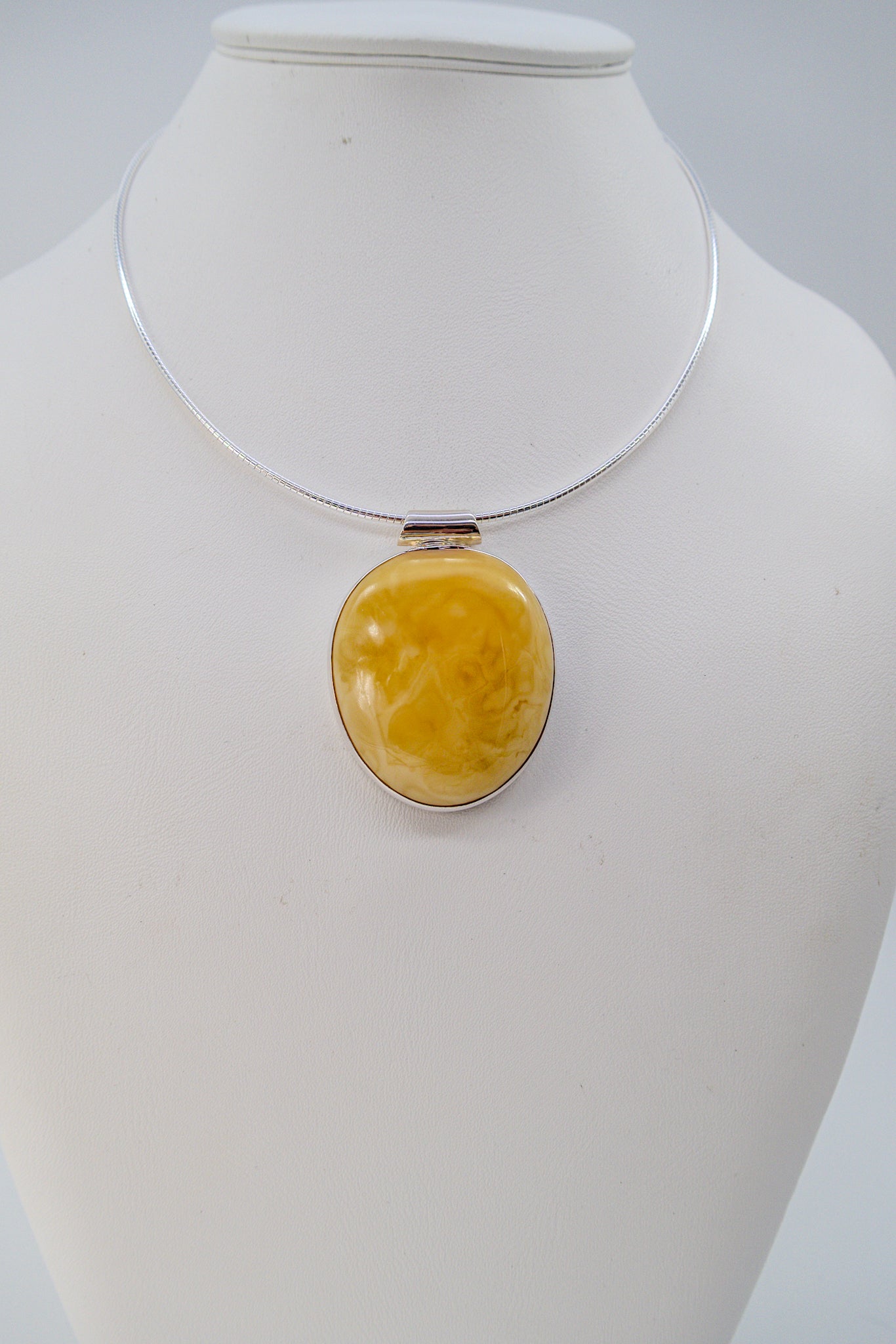 Handmade silver pendant with yellow amber