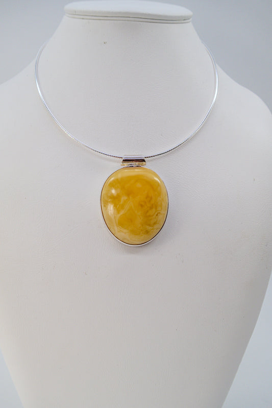 Handmade silver pendant with yellow amber