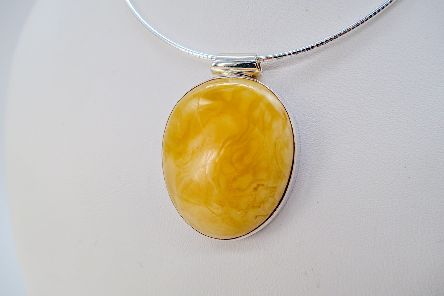 Handmade silver pendant with yellow amber