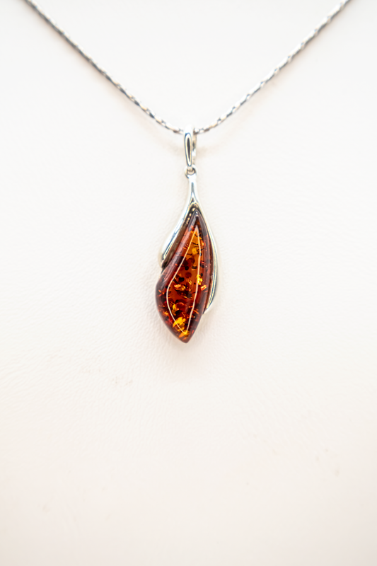 Amber drop pendant in modern silver setting
