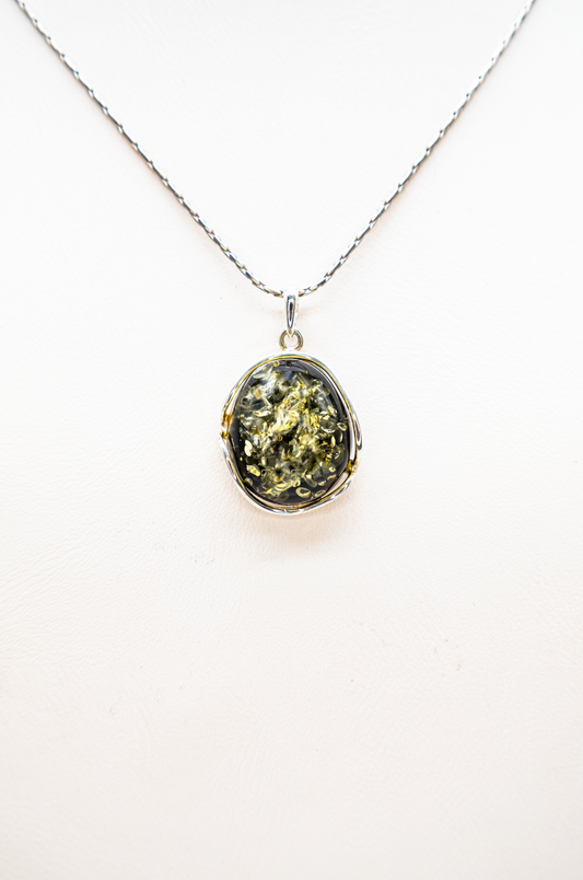 Oval silver pendant with green amber – unique piece