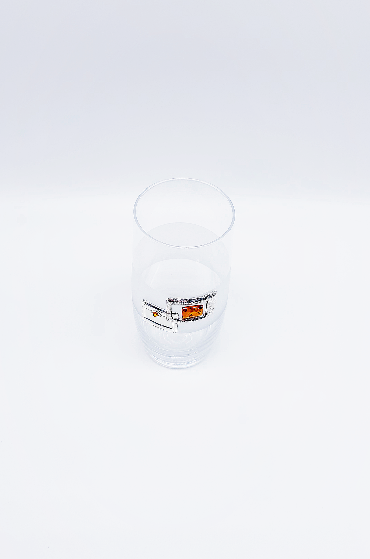 Elegant drinking glass with amber and silver accents
