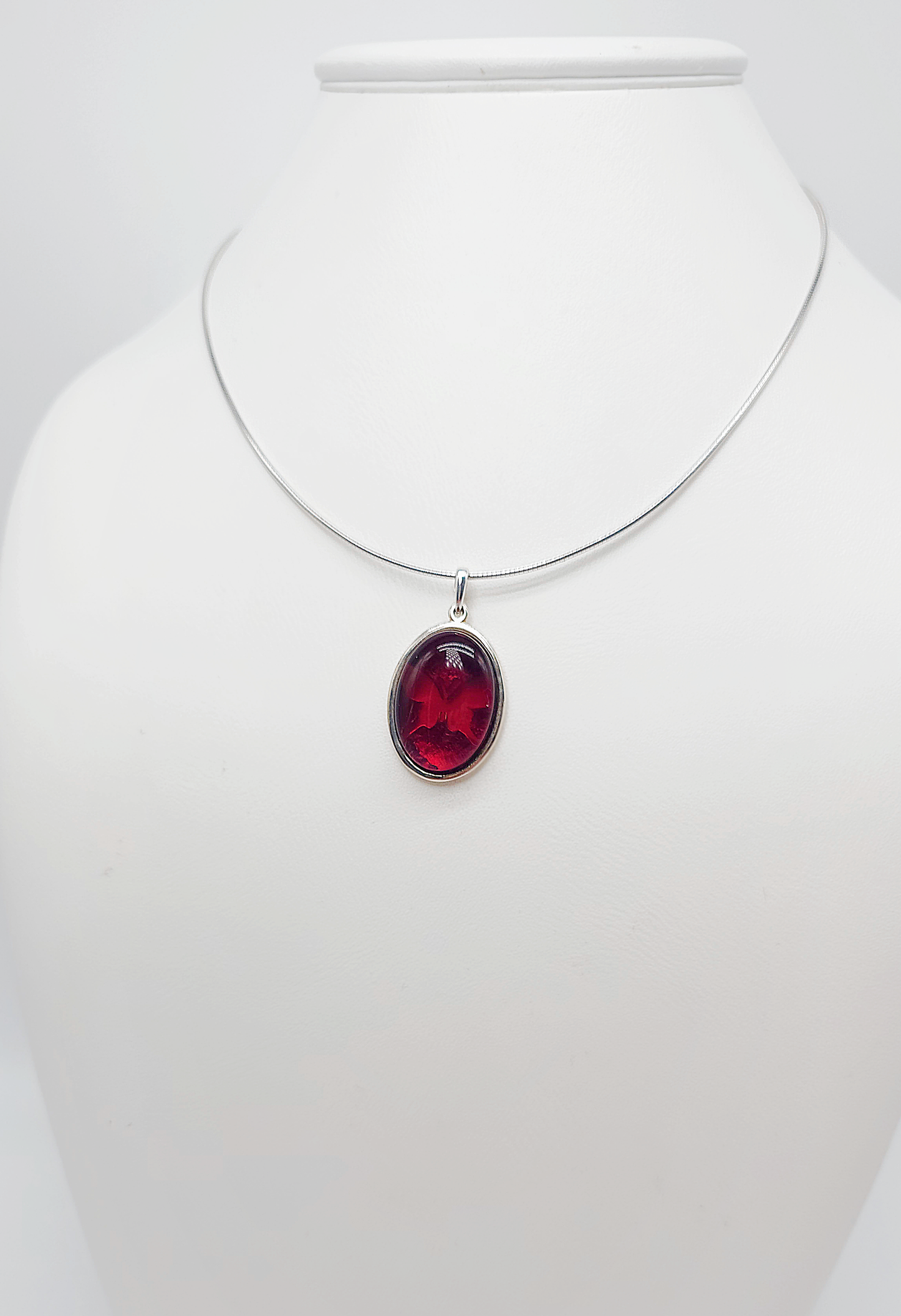 Silver pendant with red amber and butterfly design