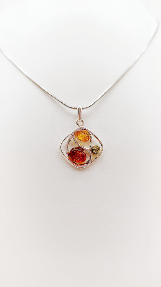 Elegant harmony: colored amber in a silver frame