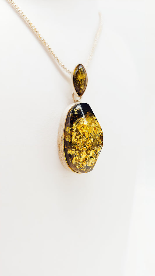 Unique pendant with golden amber and silver