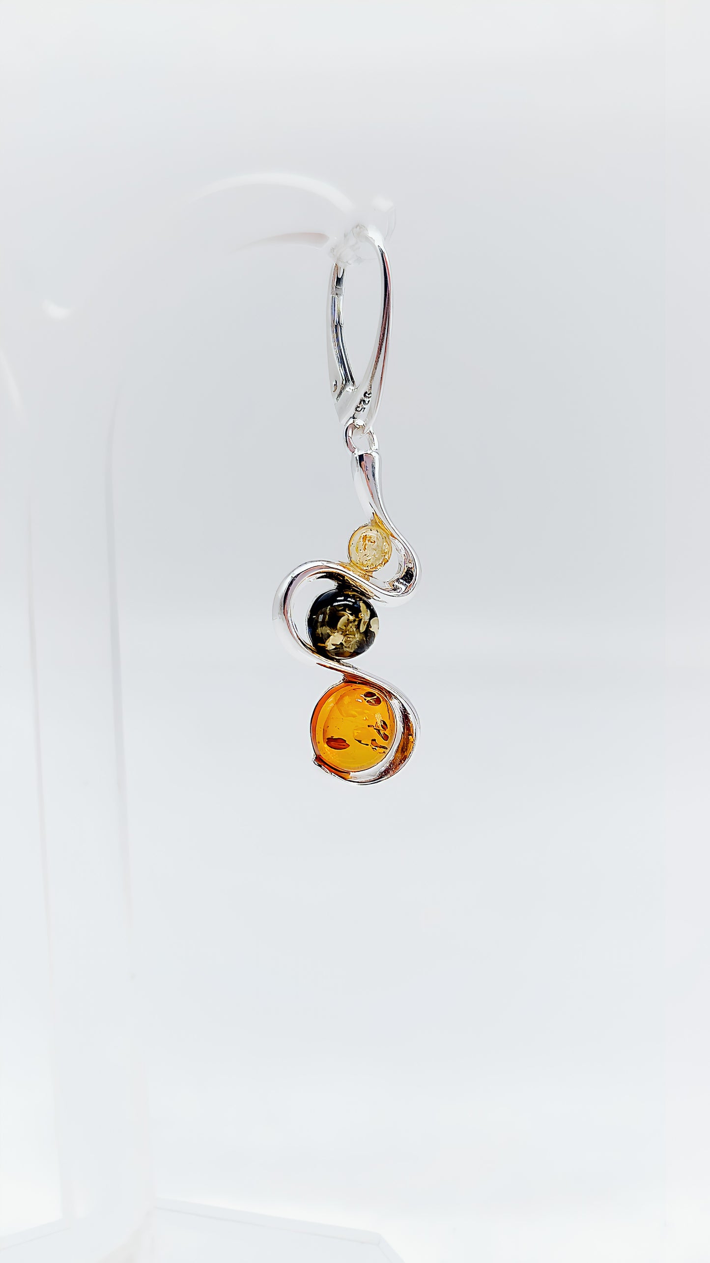 Three colors, one design: earrings with colorful amber