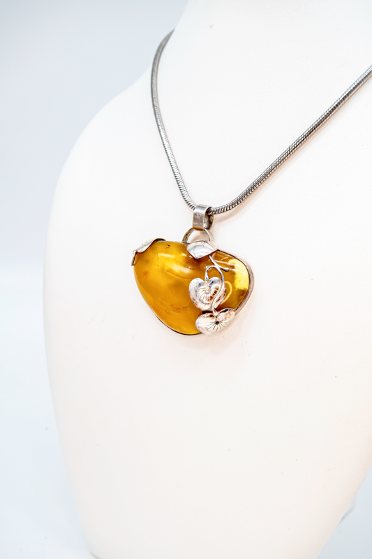 Striking amber pendant with silver ornaments