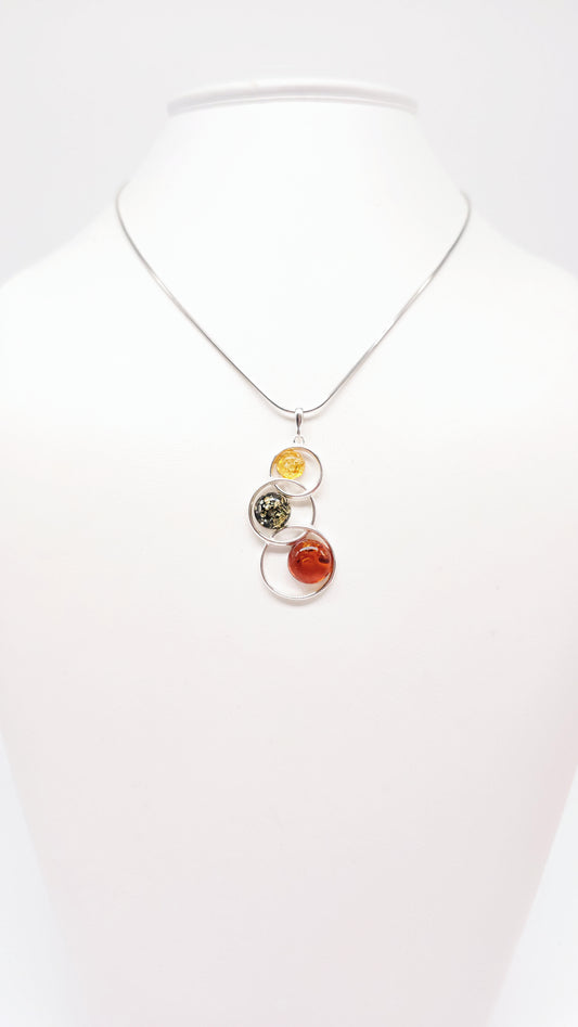 Colored amber pendant in silver setting