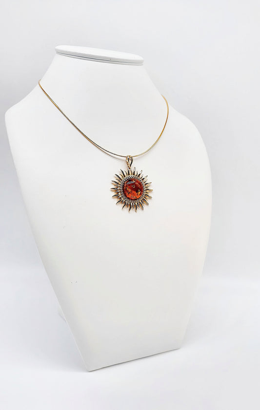 Gold-plated sun pendant with amber