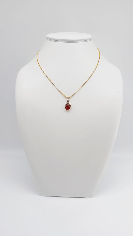 Elegant amber pendant in gold-plated setting