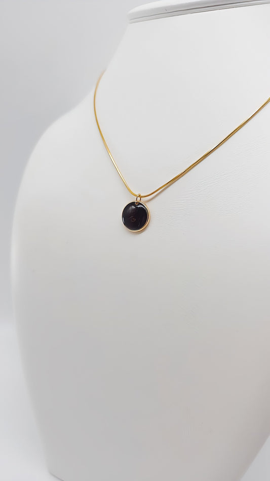 Radiant black gold pendant with amber