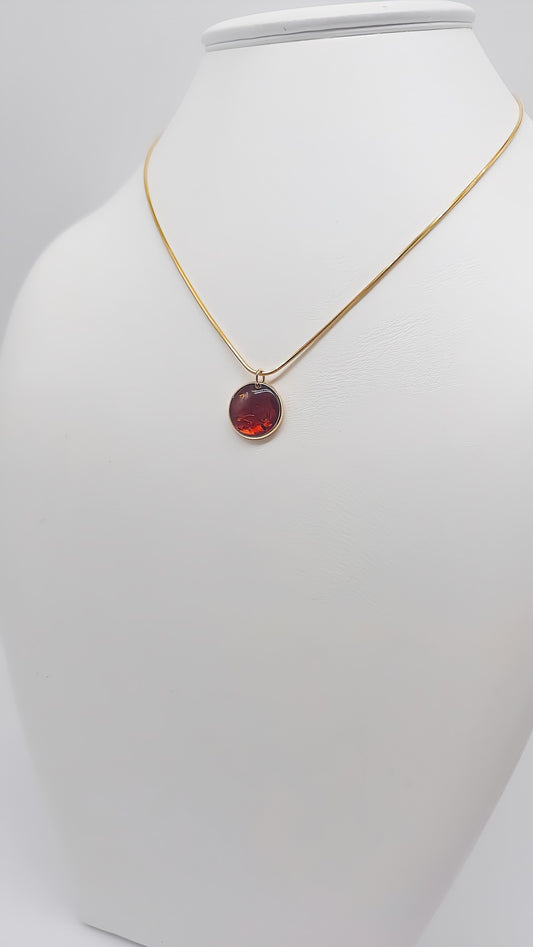 Brilliant accent: Gold-plated pendant with amber