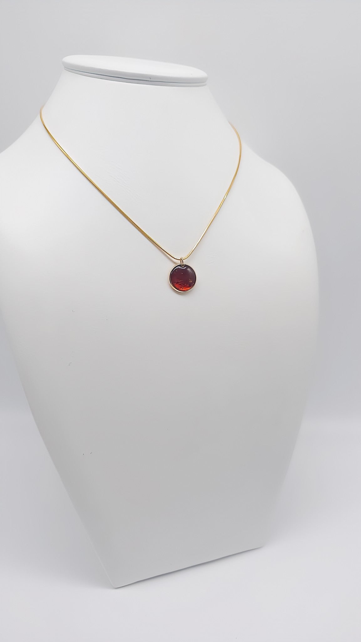 Brilliant accent: Gold-plated pendant with amber