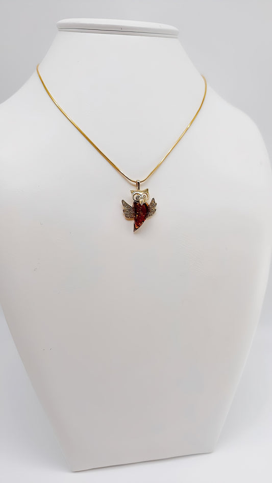 Wisdom and splendor: Gold-plated owl pendant with amber