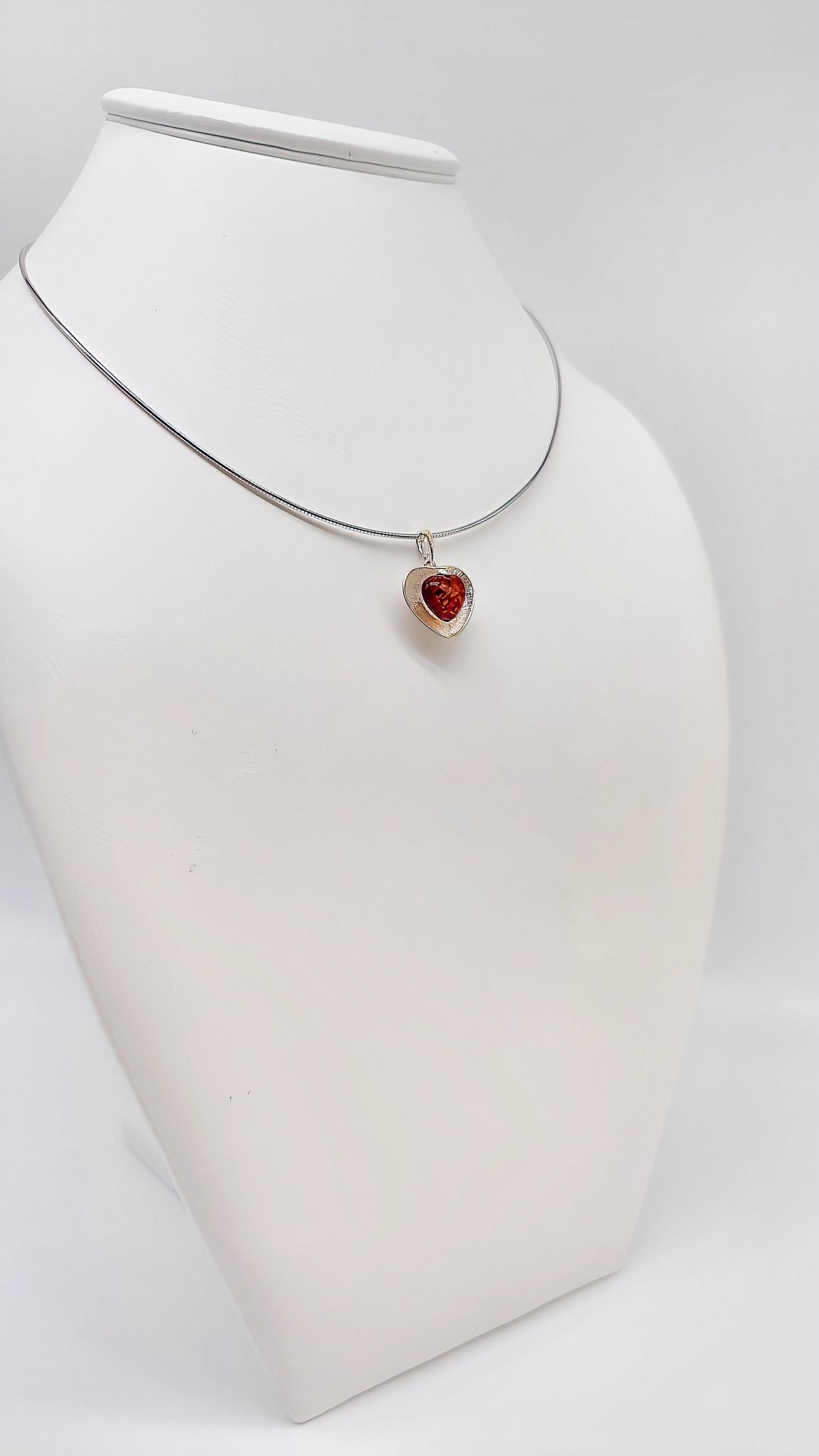 Silver heart pendant with amber