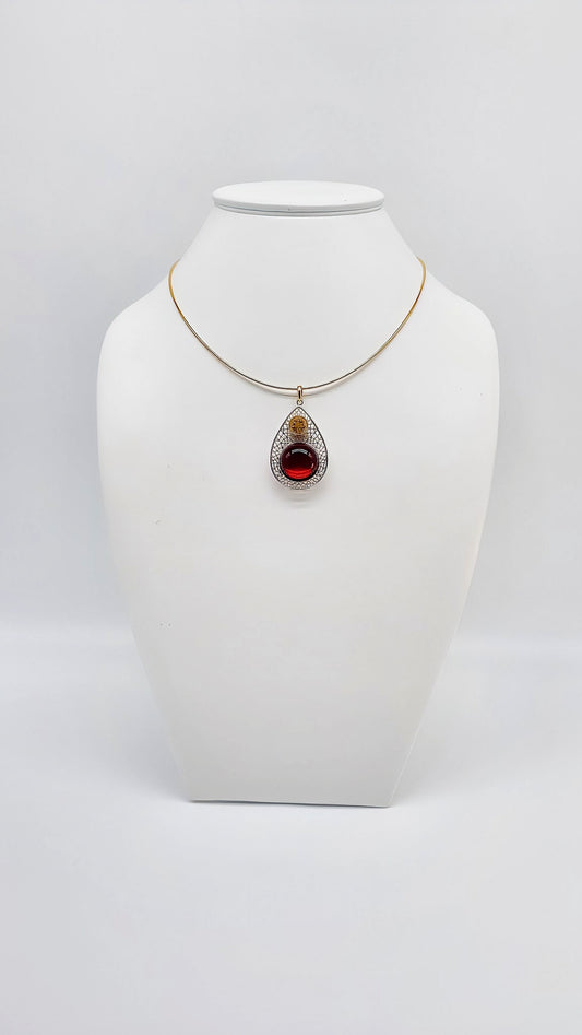 Luxurious drop pendant with ruby red amber