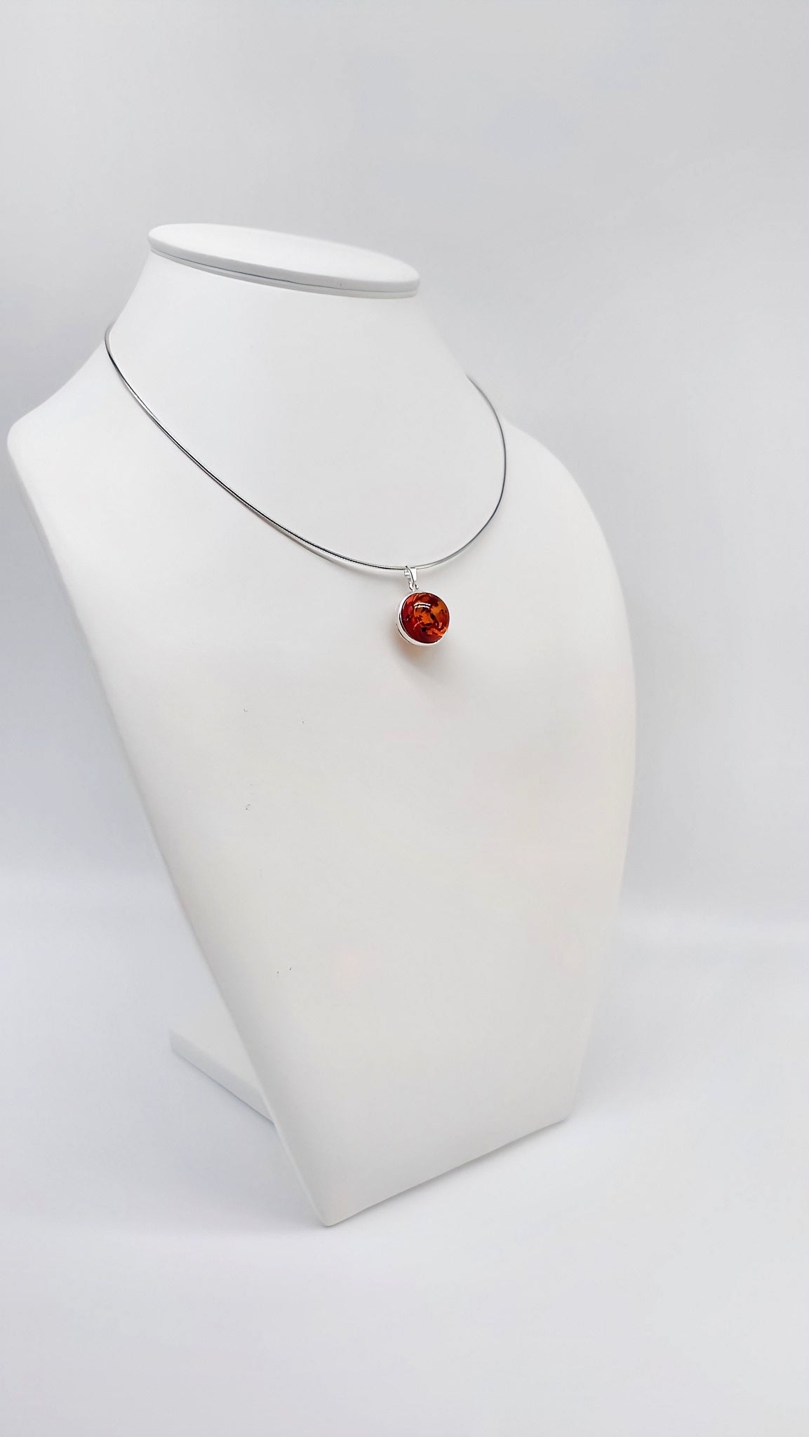 Elegant silver pendant with amber