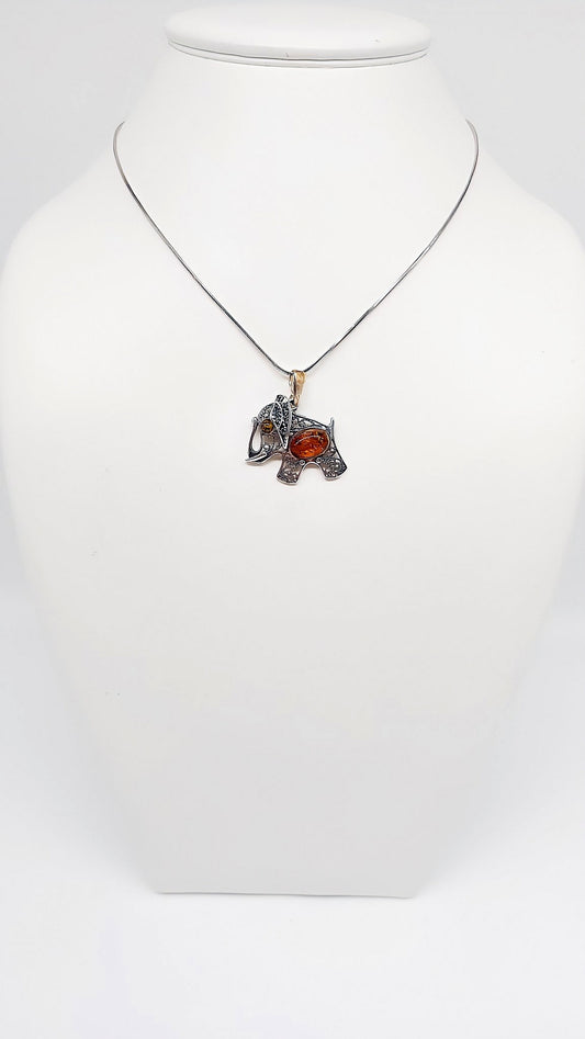 Filigree elephant pendant made of sterling silver with amber