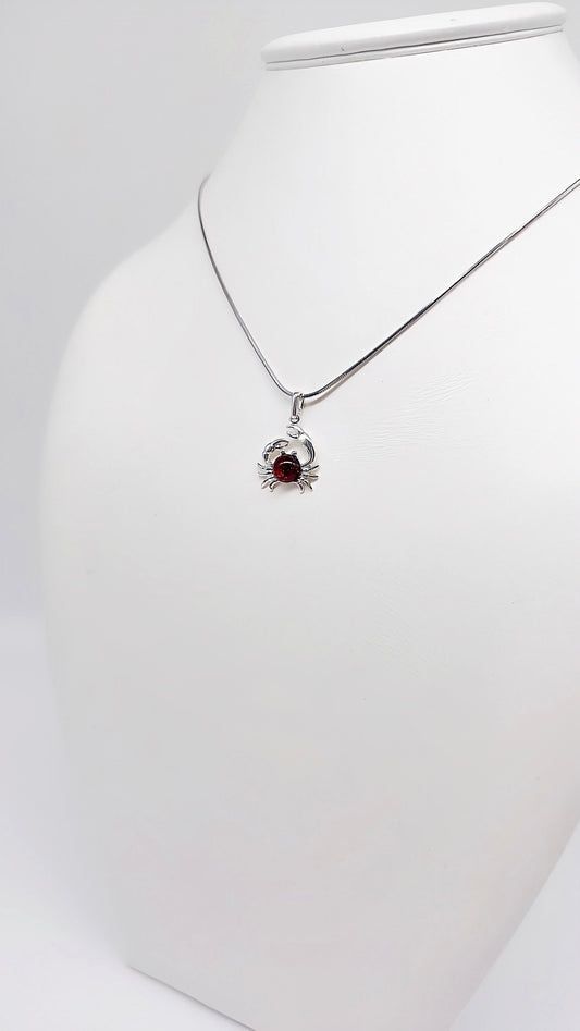 Elegant crab pendant with amber