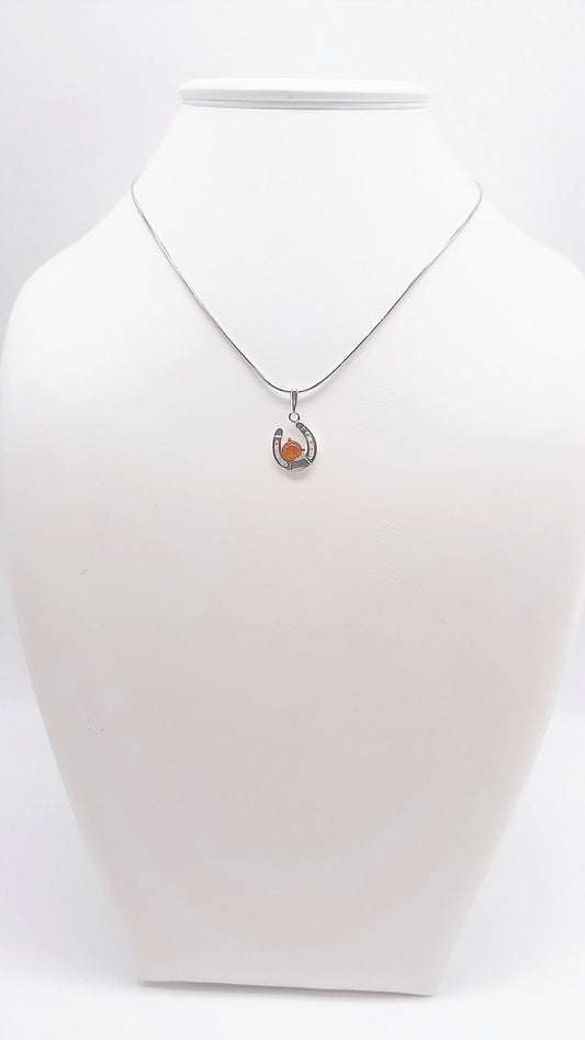 Lucky charm: horseshoe pendant with amber