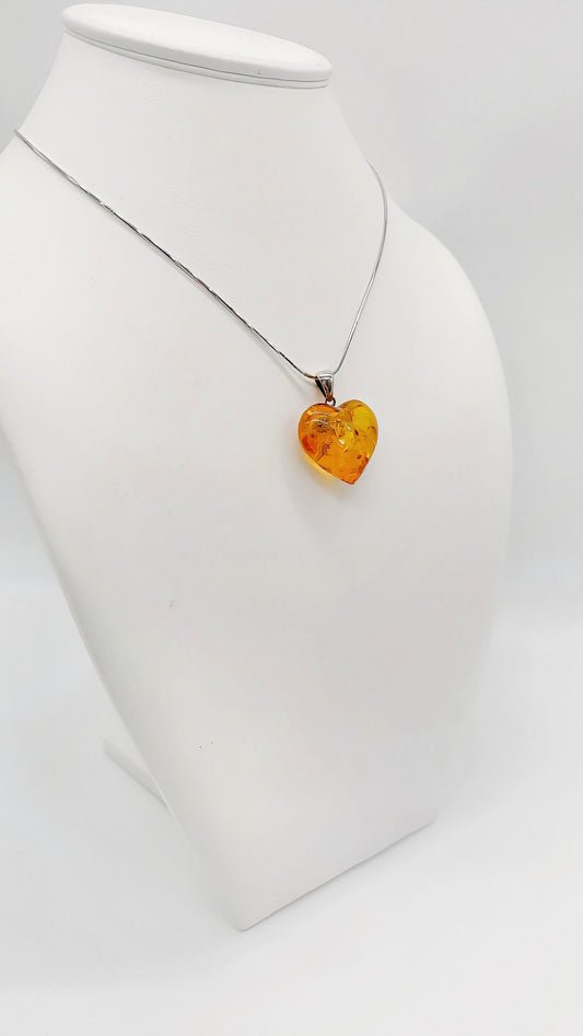 Heart pendant made of amber with 925 silver eyelet