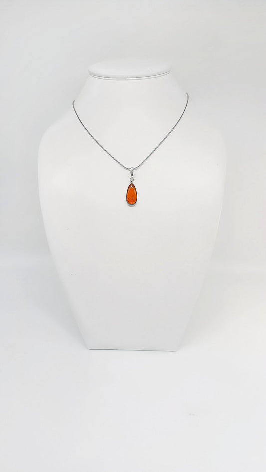 Drop-shaped silver pendant with amber