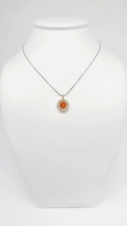Stylish pendant made of silver, amber and gold-plated details