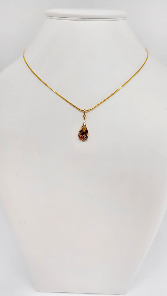 Radiant drop pendant with amber