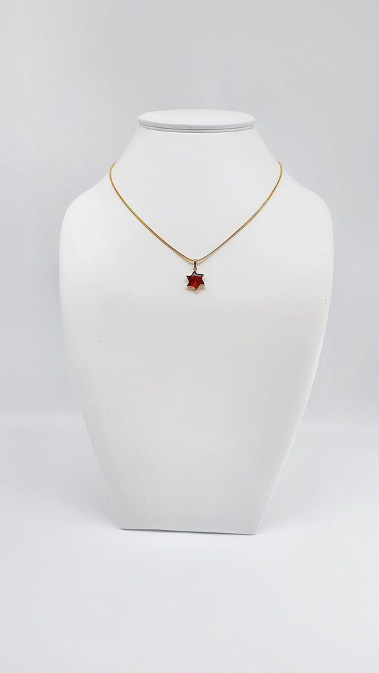 Radiant star pendant with amber