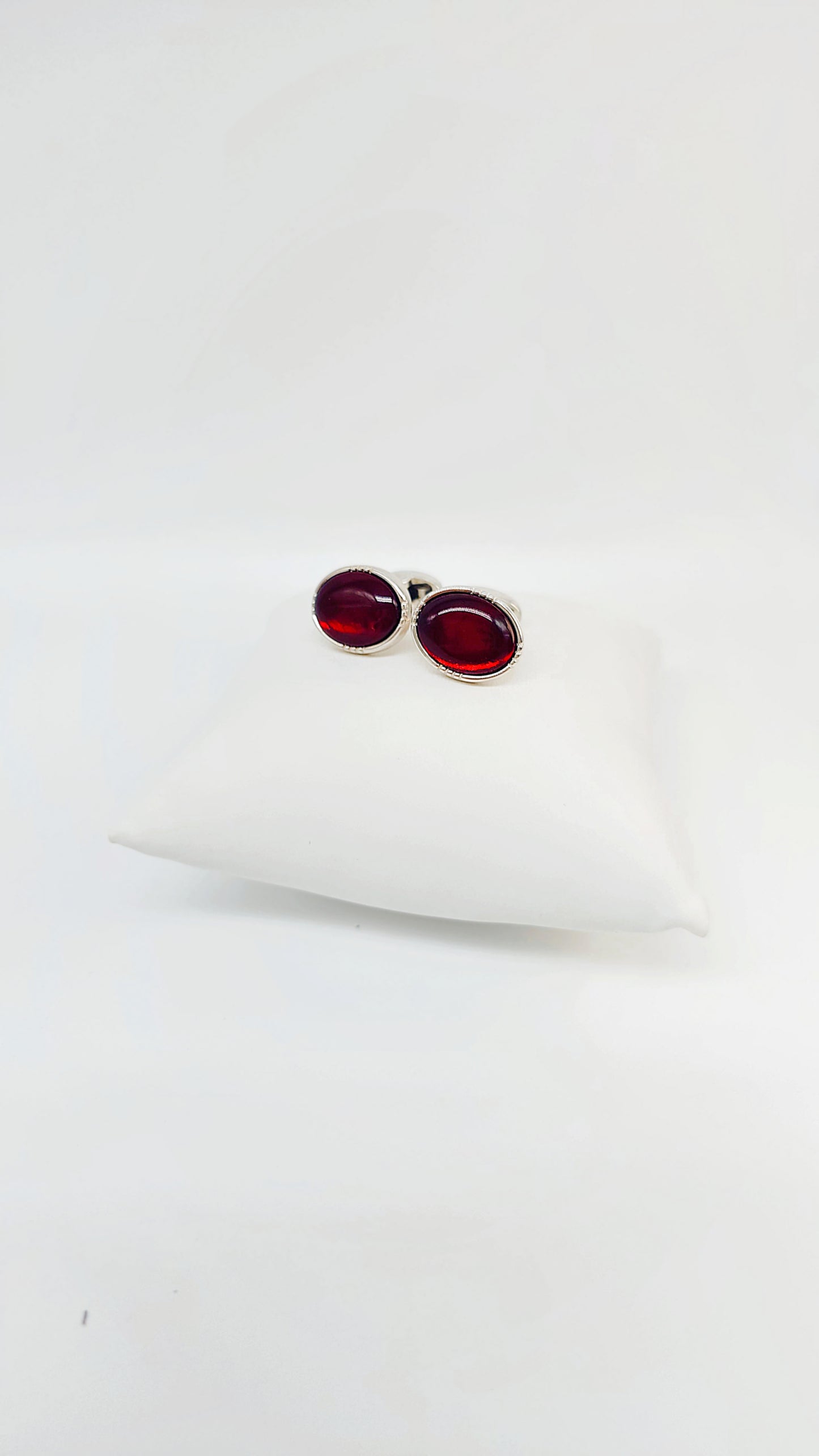 Handmade cufflinks made of 925 sterling silver with dark red amber