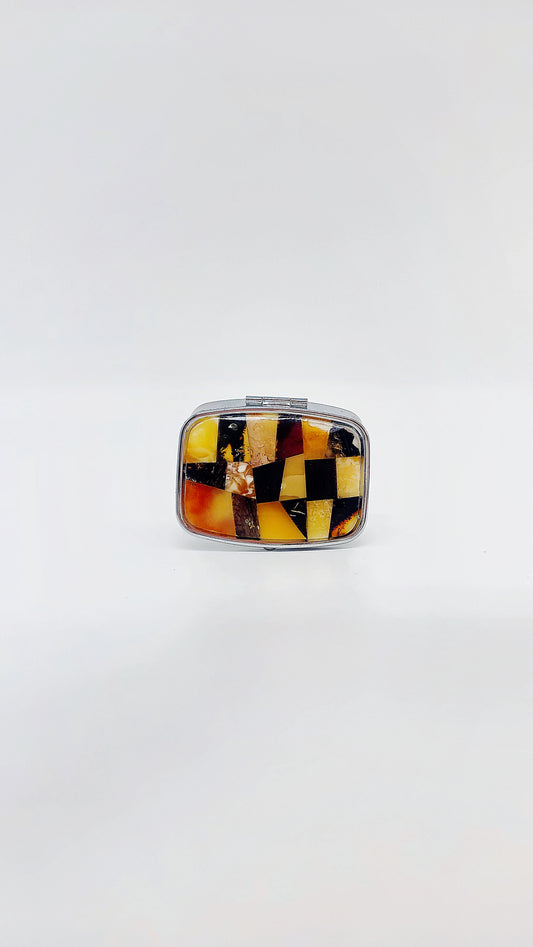Mini pill box made of stainless steel with natural amber