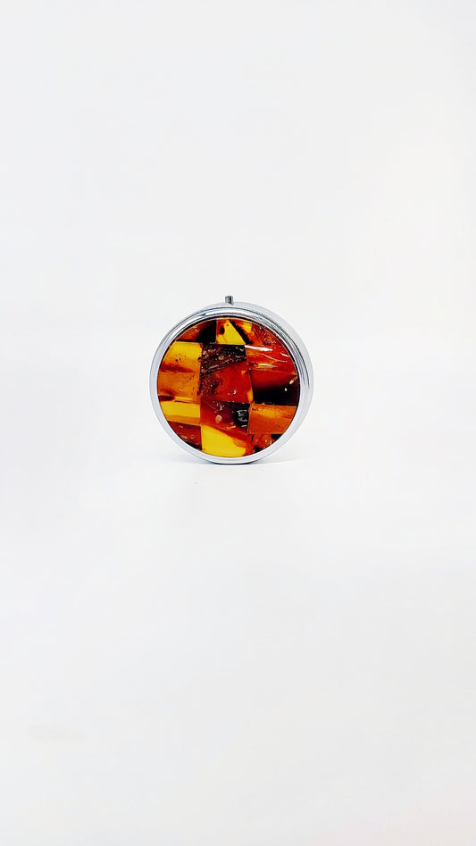 Round amber pill box made of stainless steel – high-quality unique piece