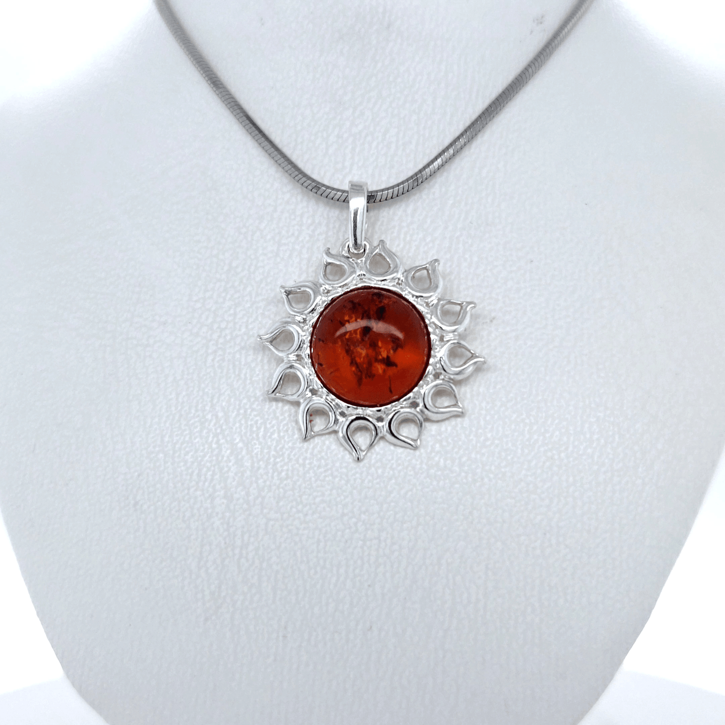 Silver jewelry pendant with amber sun
