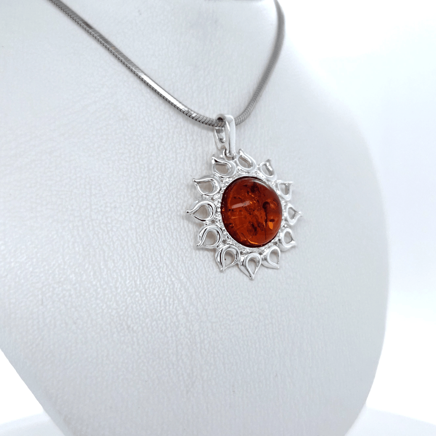 Silver jewelry pendant with amber sun