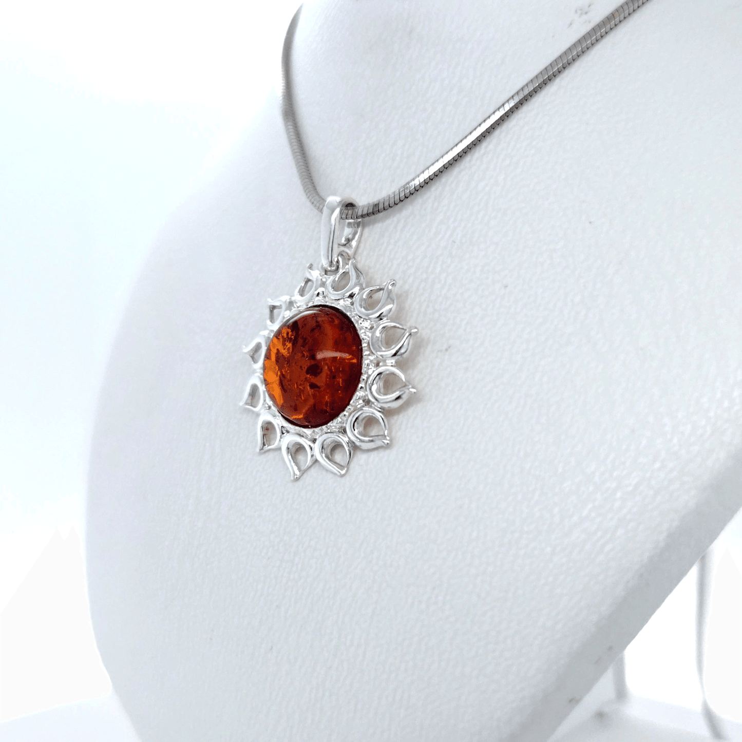 Silver jewelry pendant with amber sun
