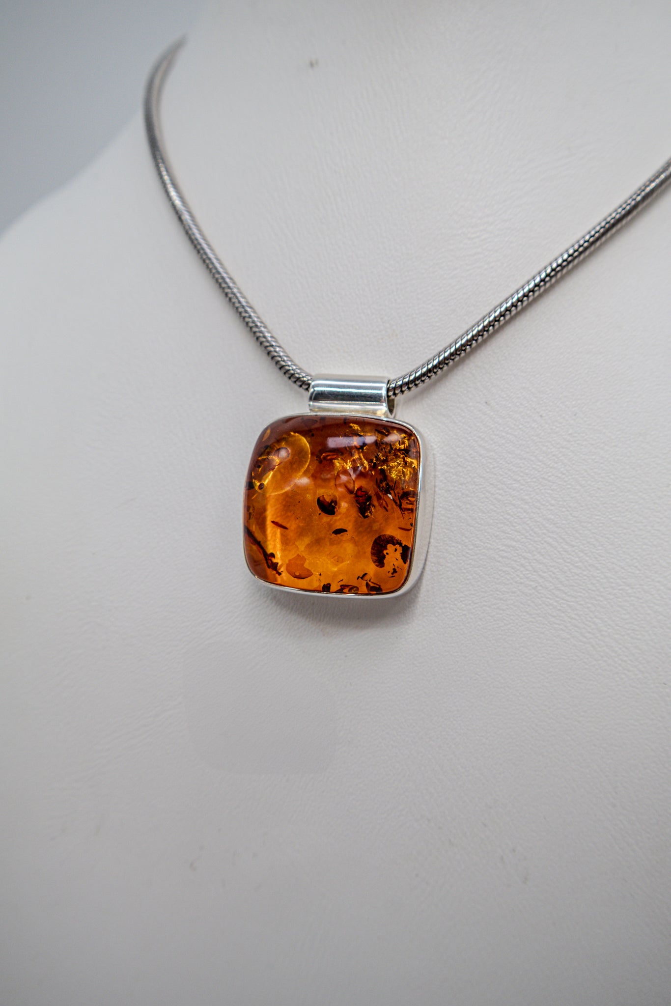 Unique amber pendant in a modern silver setting