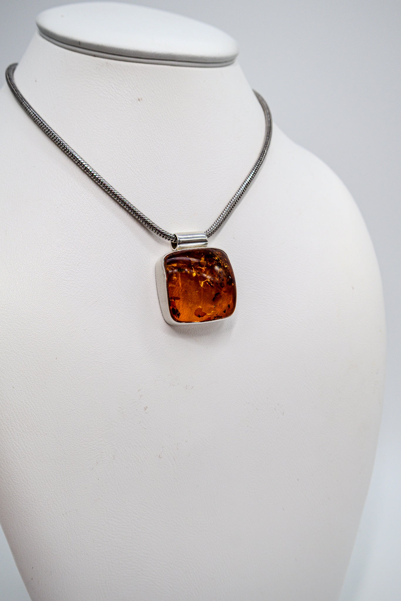 Unique amber pendant in a modern silver setting